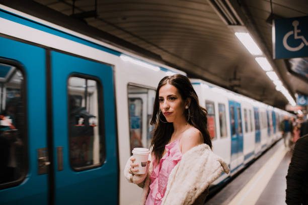 Young woman drinking coffee inside the underground stock photo