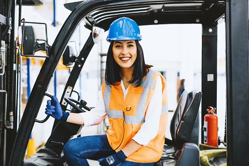 Young Woman Driving A Forklift At Warehouse Stock Photo Download Image Now Istock