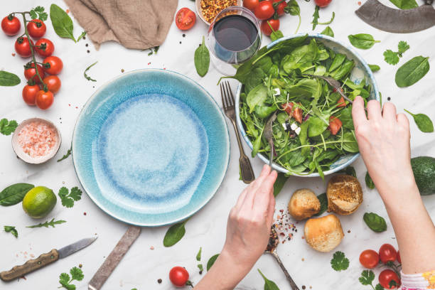 jonge vrouw die verse gezonde salade eet - vegan keto stockfoto's en -beelden