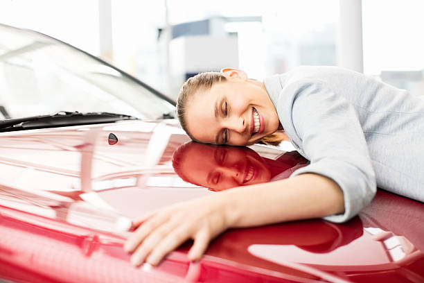Young Woman Embracing Her New Car stock photo
