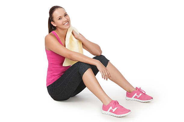 Young woman exercising against white background stock photo