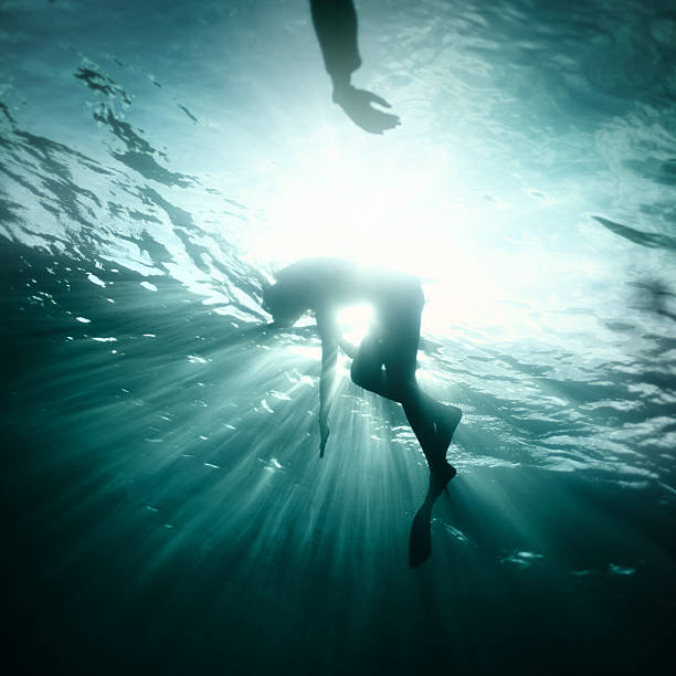 Young woman fall into deep water stock photo