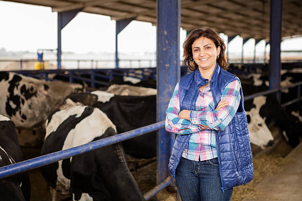 Young Woman Farmer Young farmer posing in animal farm. rancher stock pictures, royalty-free photos & images