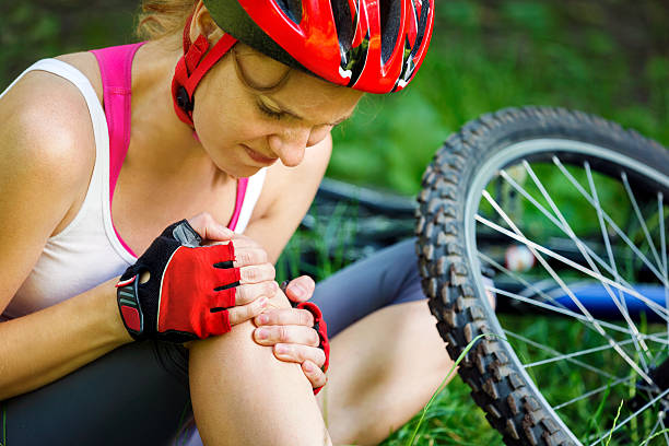 Young woman fell off mountain bike. stock photo