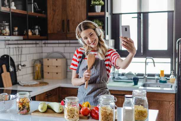 Young woman having fun in the kitchen stock photo