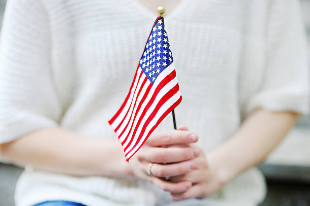 Young woman holding american flag close up Young woman holding american flag. Independence Day concept. fiancé stock pictures, royalty-free photos & images