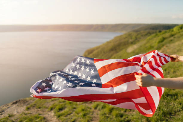 Young woman holding USA flag for freedom concept. American flag. stock photo