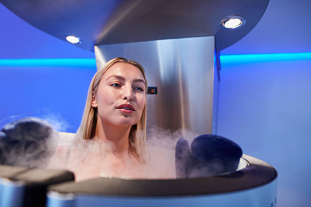 young woman in a full body cryotherapy cabinet - ice bath bildbanksfoton och bilder