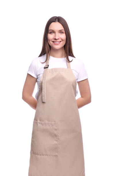 Young woman in apron portrait Young woman in apron isolated on white background apron stock pictures, royalty-free photos & images