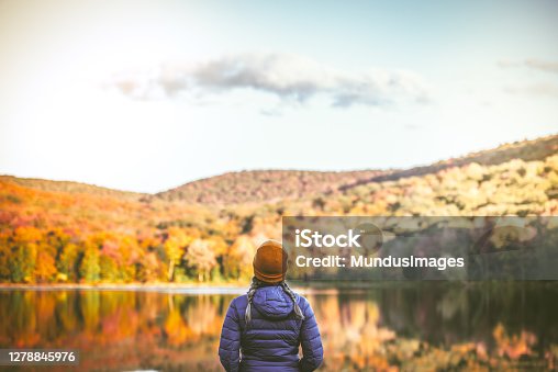istock Young Woman in Autumn Landscape. 1278845976