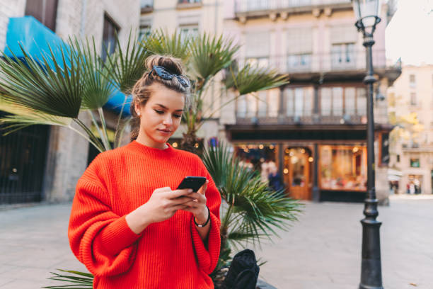 Young woman in Barcelona using smartphone stock photo