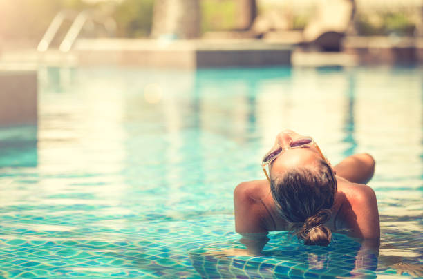 Young woman in the swimming pool stock photo