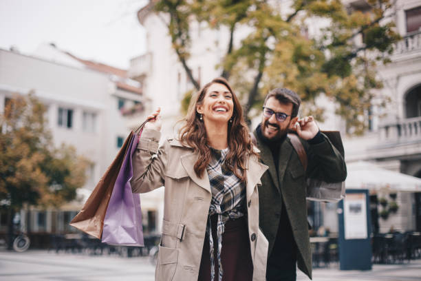 Young woman is enjoying her time with her boyfriend, shopping. stock photo