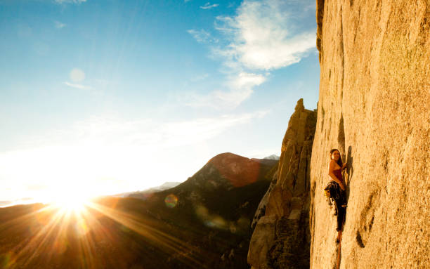 Young woman leading a climbing route in Colorado stock photo