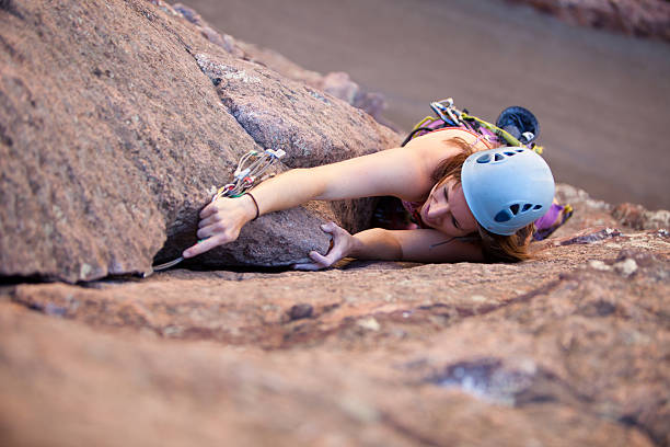 Young woman leading a climbing route in Colorado stock photo