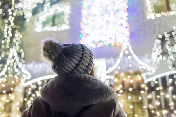 joven mirando casa decorada con luces de navidad. - christmas lights house fotografías e imágenes de stock