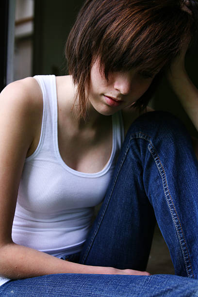 Young Woman Looking Down stock photo