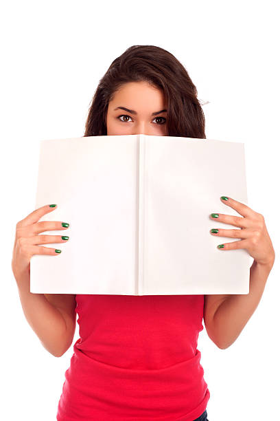 Young woman looking over magazine stock photo