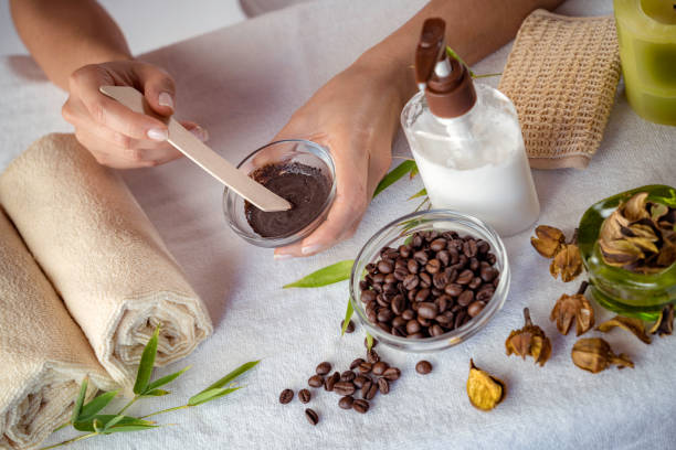 Young woman making coffee facial mask for skin scrub treatment stock photo