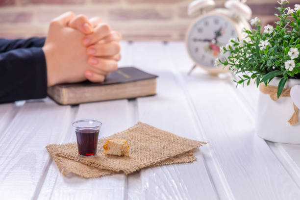 Young woman praying and Taking communion stock photo