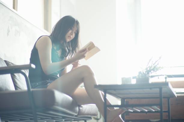 家で読書若い女性 - 朝活　読書 ストックフォトと画像