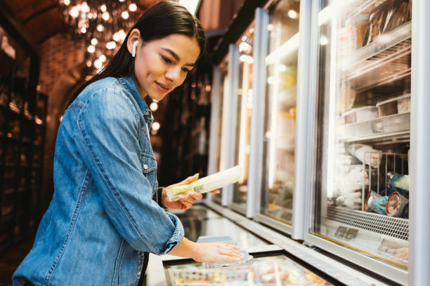 Young woman shopping food at grocery store stock photo