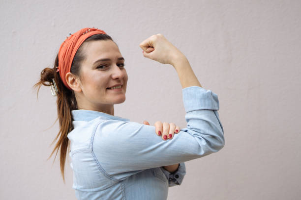 Young woman shows her strong arm stock photo