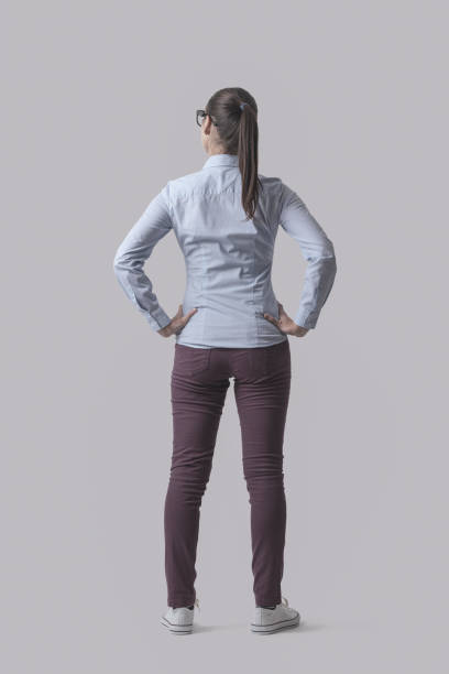 Young woman standing back view stock photo
