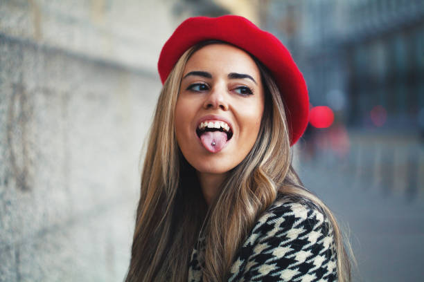 Young woman sticking out tongue stock photo