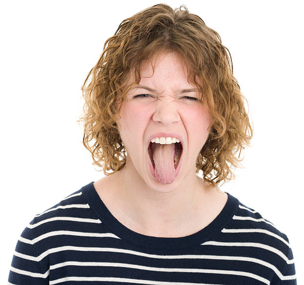 Young Woman Sticking Out Tongue Portrait of a young woman on a white background. http://s3.amazonaws.com/drbimages/m/as2.jpg ugly skinny women stock pictures, royalty-free photos & images