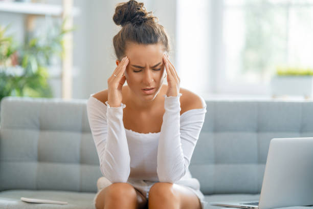 Young woman studying and having a head ache