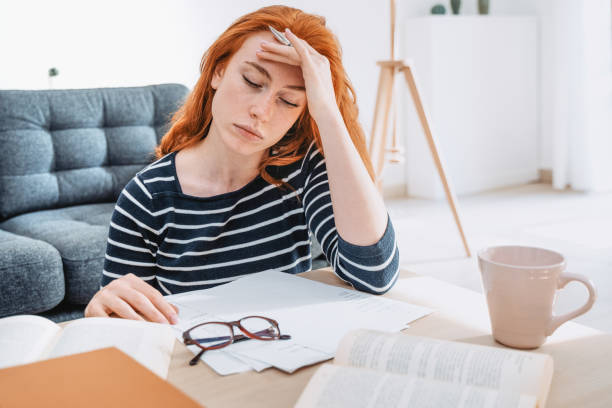 Young woman studying at home and doing homework Girl portrait having school lesson at home student debt stock pictures, royalty-free photos & images