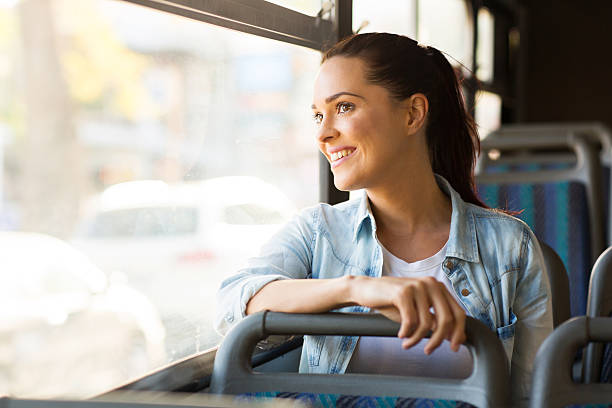 young woman taking bus to work - openbaar vervoer stockfoto's en -beelden