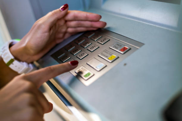 Young woman using an ATM. stock photo