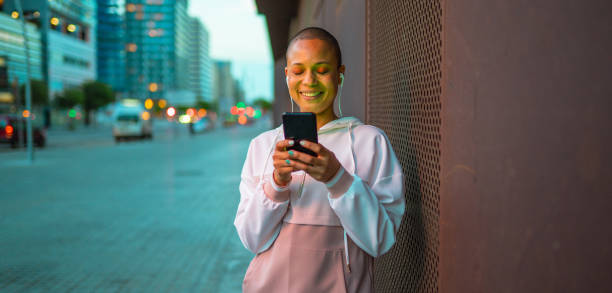 Young woman using phone at the street stock photo