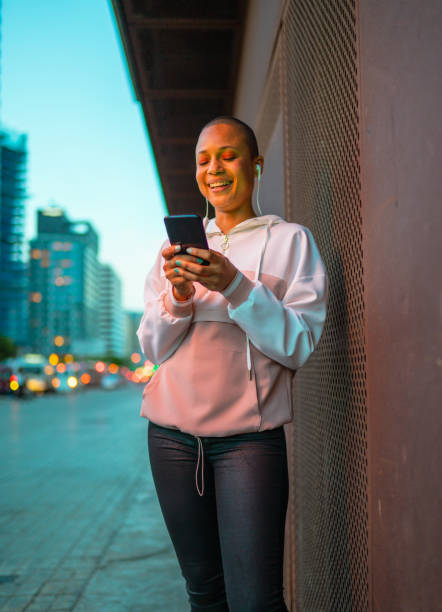 Young woman using phone at the street stock photo