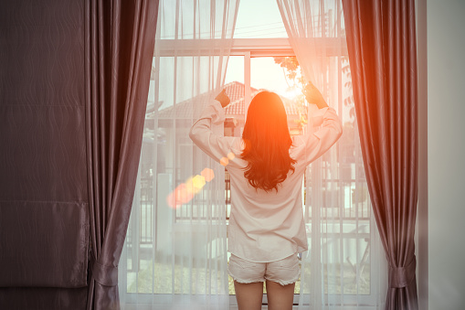 Young Woman Wake Up In The Morning And Open Window After Waking On Bed ... Open Window At Morning