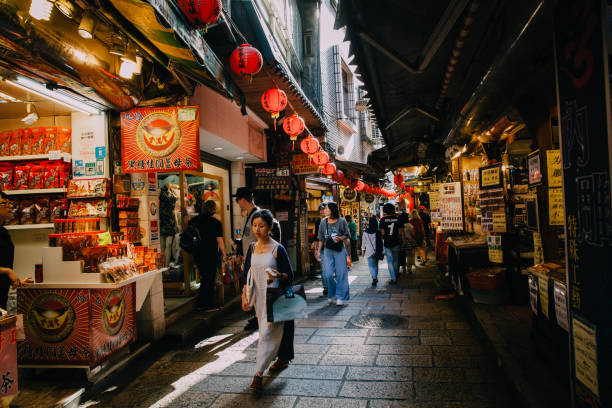 A young woman walks with purchases in Jiufen, Taiwan stock photo