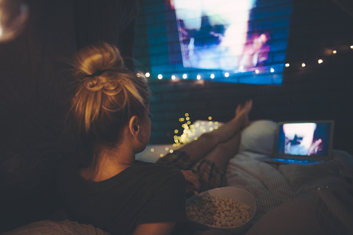 Young Woman Watching Movies In Home Theater Stock Photo - Download ...