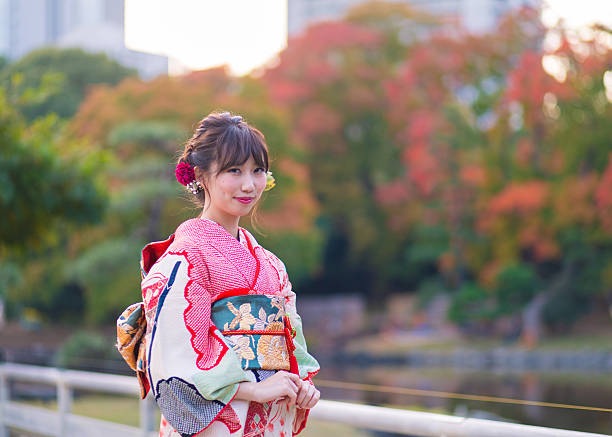 Young woman wearing Furisode in autumn foliage Young woman wearing Furisode in autumn foliage furisode stock pictures, royalty-free photos & images