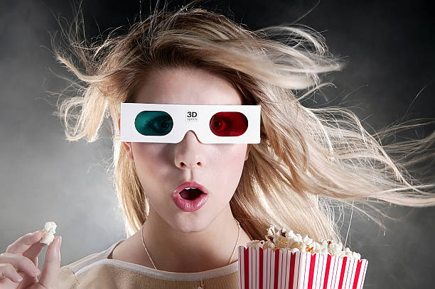 young woman with 3D movie glasses and popcorn  3 d glasses stock pictures, royalty-free photos & images