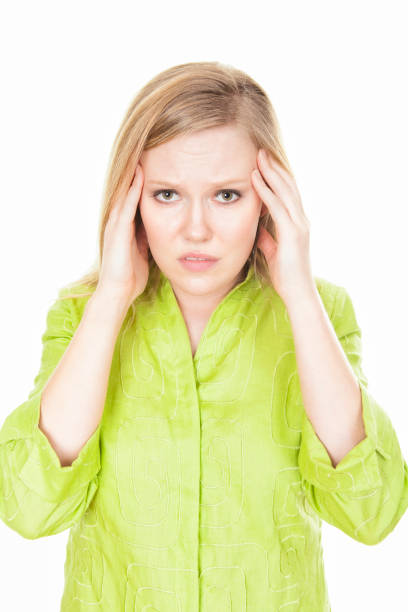 Young woman with excrutiating heachache stock photo