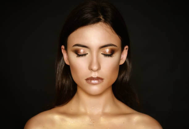 Young woman with golden makeup. stock photo