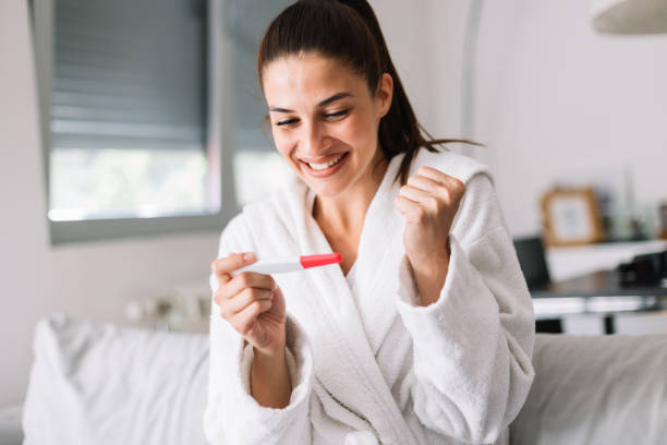 Young woman with pregnancy test stock photo