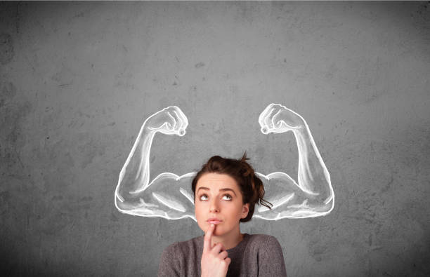 Young woman with strong muscled arms Pretty young woman with sketched strong and muscled arms strength stock pictures, royalty-free photos & images