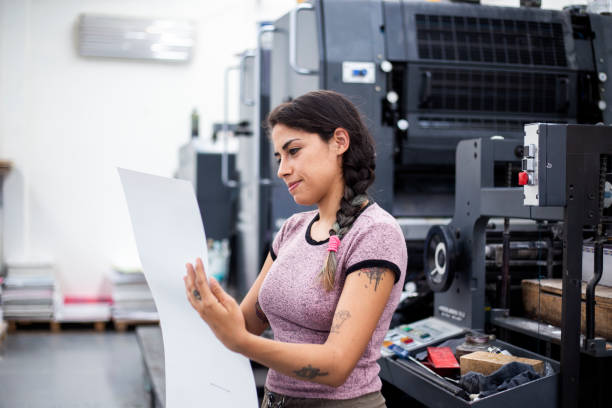 Young woman working in a printing press stock photo