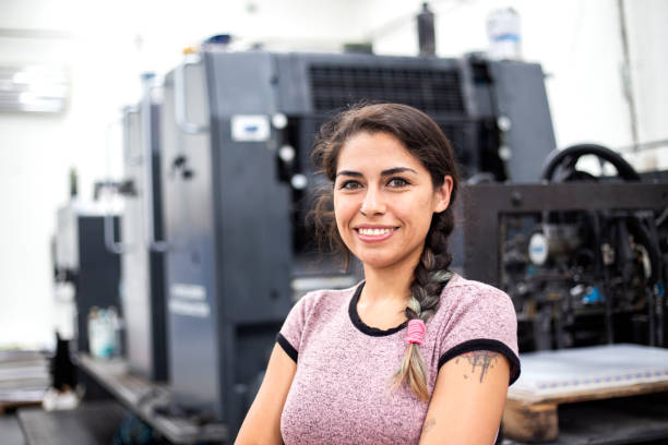 Young woman working in a printing press stock photo