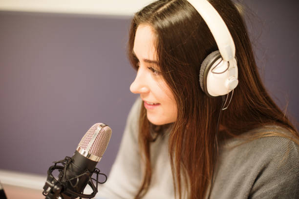 Young woman working in a radio station stock photo