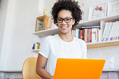 istock Young woman working with orange laptop in studio 544489251