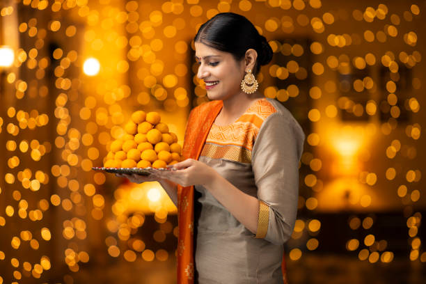 young women celebrate diwali Indian culture, Indian, Diwali, women, adult mithai stock pictures, royalty-free photos & images